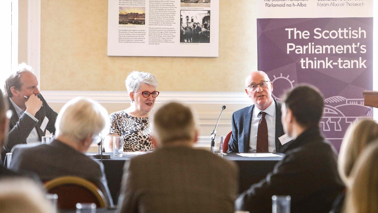 People sitting at top table in event